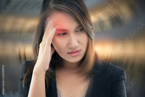 Working woman has Headache Against gray background, Benign Paroxysmal Positional Vertigo: BPPV, Concept with Sickness and Healthcare. photo