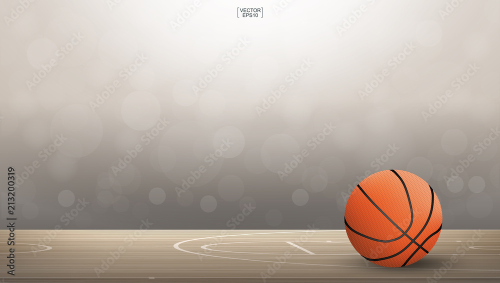 Obraz premium Basketball ball on basketball court area with light blurred bokeh background. Abstract background for basketball sport with light effect. Vector.