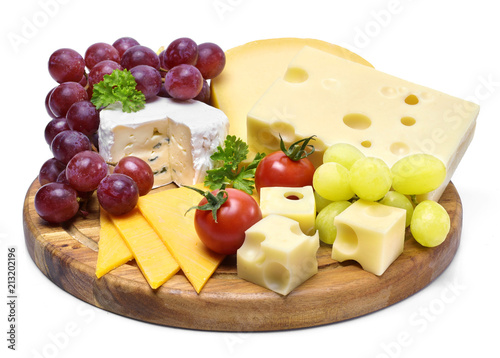 Delicious cheese plate with various sorts of cheese like Emmentaler, gouda and brie. Gourmet cheese on a wooden cutting board, isolated on white background.