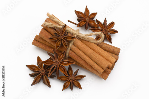 Cinnamon sticks and cardamom on a white background. Aromatic spices.