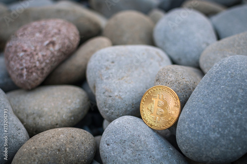 Cryptocurrency on the shore among the big sea stones