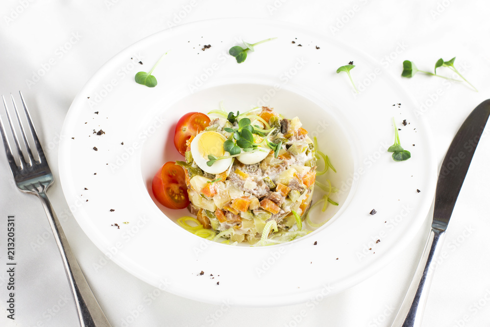 Russian Olivier salad with meat, quail eggs and cherry tomatoes Russian Olivier salad with meat, quail eggs and cherry tomatoes