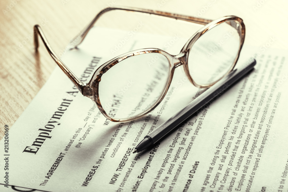 Close up shot of Eyeglasses on contract document papers business concept Close up shot of Eyeglasses on contract document papers business concept