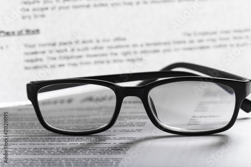 Close up shot of Eyeglasses on document papers business concept