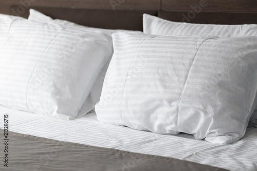 white pillows on bed in modern bedroom at home