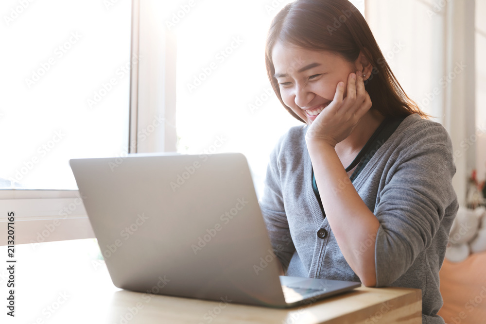 Portrait of a happy female using laptop computer in cafe. Portrait of a happy female using laptop computer in cafe.
