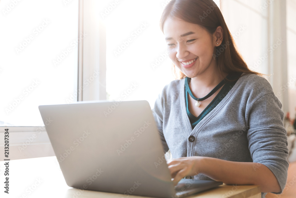 Portrait of a happy female using laptop computer in cafe. Portrait of a happy female using laptop computer in cafe.