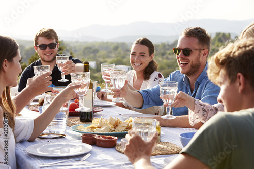 Group Of Young Friends Enjoying Outdoor Meal On Holiday