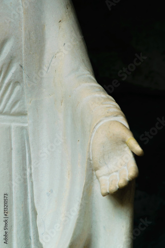 Detail of the open hand of a statue of Saint Mary