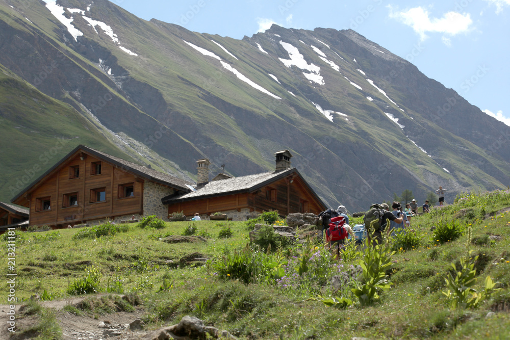 Val d'Aosta, italy, July 6 2018: group of hiker walks to reach a mountain hut