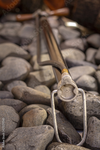 Close up shot of a antique 1930`s Automobile Tire Air Pump, photographed on pebbles background, vintage concept.