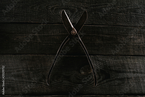  top view of retro scissors on wooden tabletop background © LIGHTFIELD STUDIOS