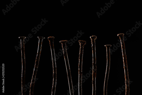 close up view of vintage rusty nails isolated on black