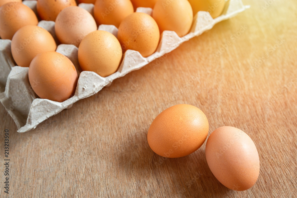 Fresh chicken eggs eggs in paper tray,egg carton on wooden background. Fresh chicken eggs eggs in paper tray,egg carton on wooden background.