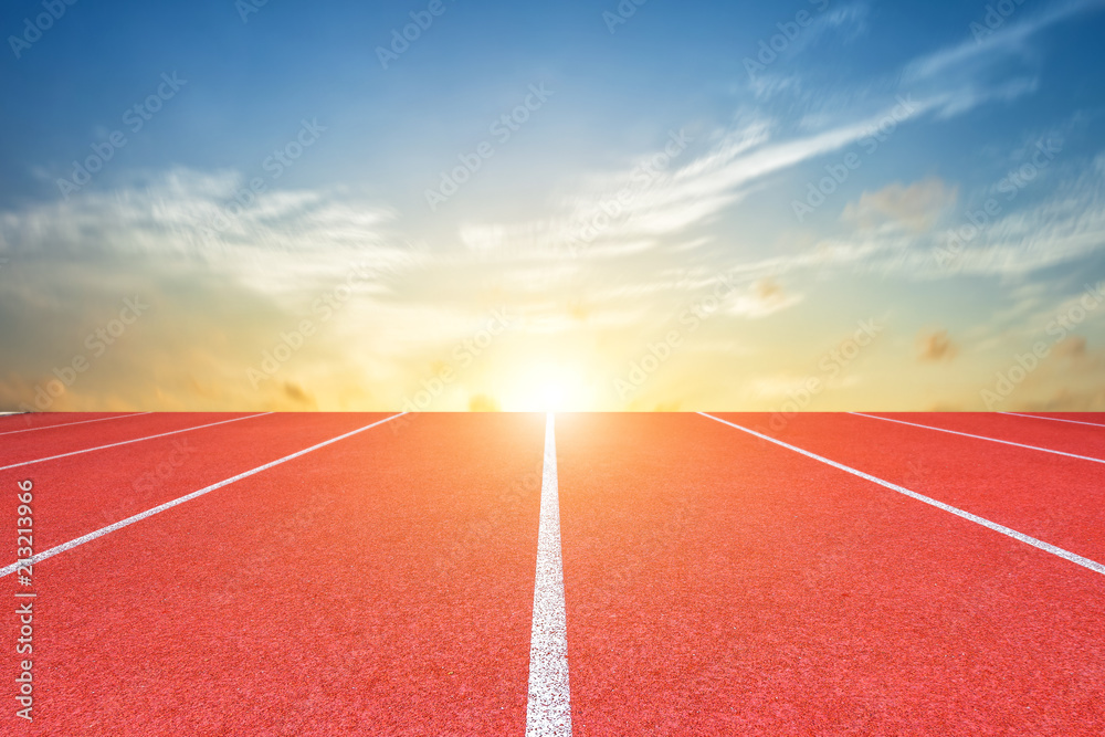 White lines of stadium and texture of running racetrack red rubber racetracks or Athlete track or running track with blue sky white cloud,sky sunset background.