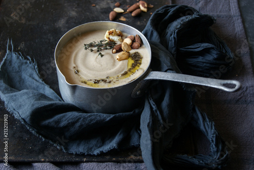 Close up of creamy cauliflower soup garnish with almonds photo