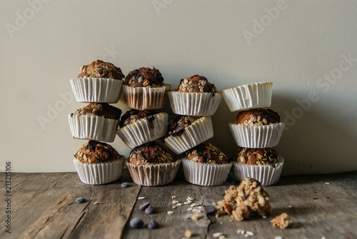 Freshly baked muffins stack on table against wall photo