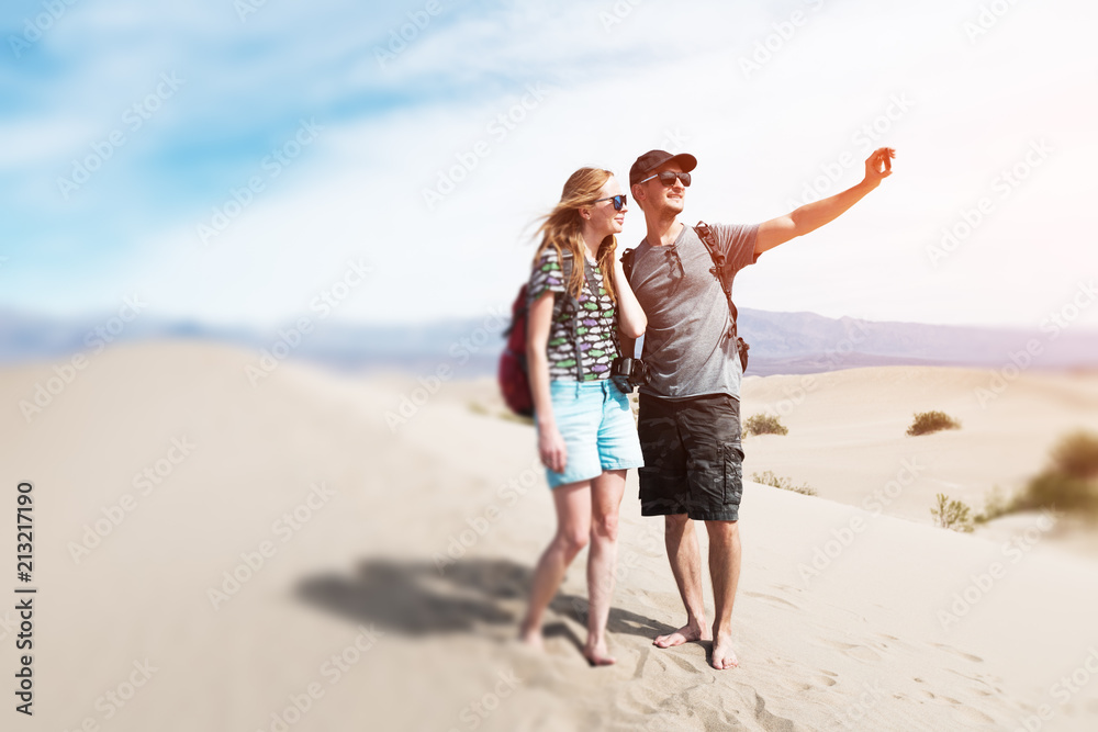 Couple of hikers takes selfie picture being on the sandy desert. The Death Valley, USA. Tilt shift effect applied Couple of hikers takes selfie picture being on the sandy desert. The Death Valley, USA. Tilt shift effect applied