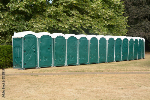 Rows of green portaloos or platic mobile toilets at festival photo