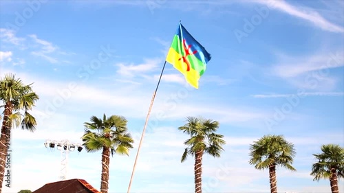 amazigh berber kabyle flag floating on clean blue sky photo