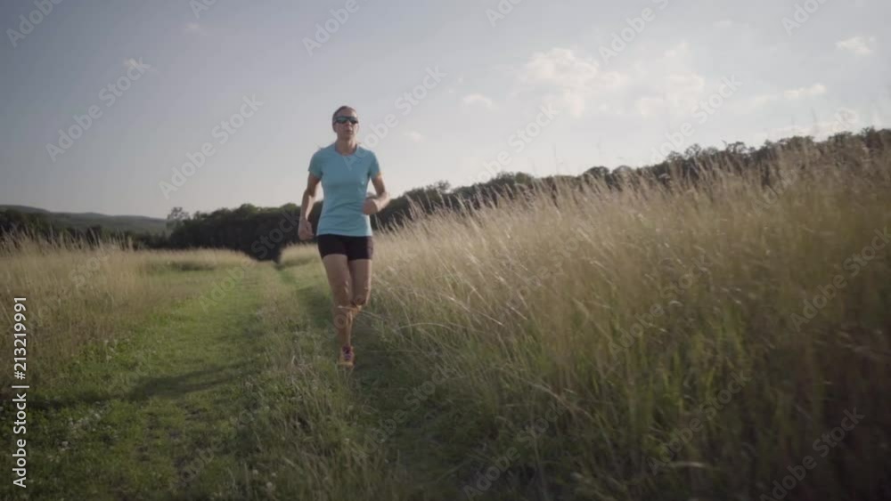 slow motion woman running on path through high dry grass
slow motion woman running on path through high dry grass