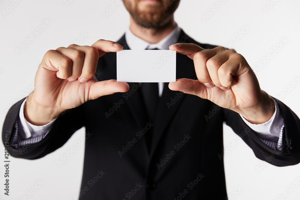 partial view of businessman presenting blank business card isolated on white background partial view of businessman presenting blank business card isolated on white background