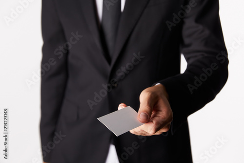 cropped image of businessman giving empty business card isolated on white background