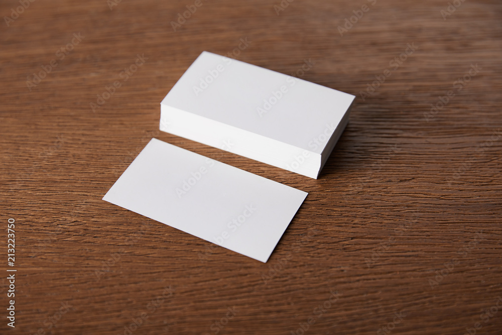 selective focus of stack of empty business cards at wooden table selective focus of stack of empty business cards at wooden table