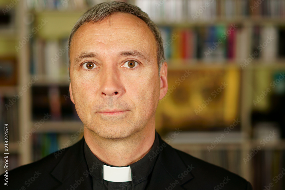 A portrait of a good looking serious catholic priest. He looks at us with interest, pensiveness, proselytising, joy, happiness, trust and peacefulness. A portrait of a good looking serious catholic priest. He looks at us with interest, pensiveness, proselytising, joy, happiness, trust and peacefulness.