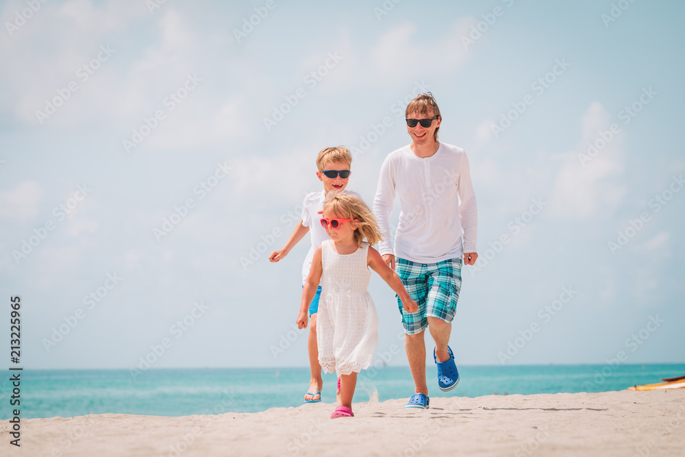 father with little son and daughter play, run at beach father with little son and daughter play, run at beach