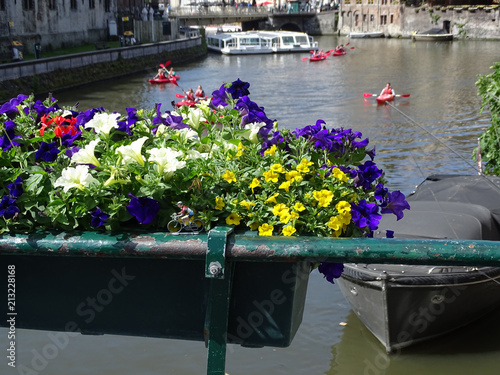 Mini bike on the water, with canoes on the Graslei, Ghent photo