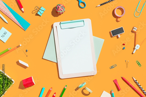 Back to school. Orange background creative flat lay desk. photo