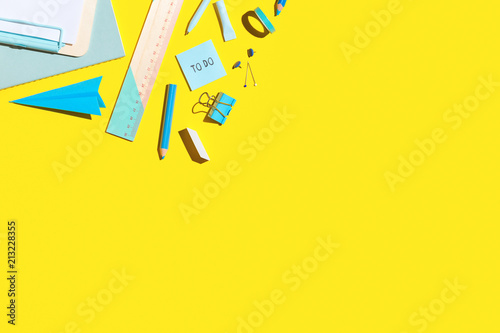 Back to school Flat lay. School supplies on yellow table. Copy space. photo