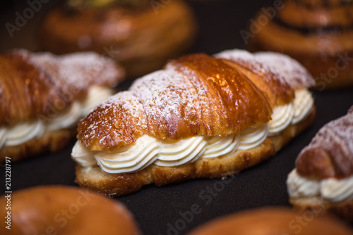 Cream croissant on dark background