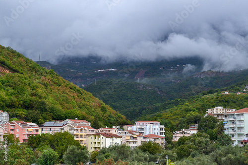 Becici, Montenegro, View of the city and mountains. Low white clouds over the city