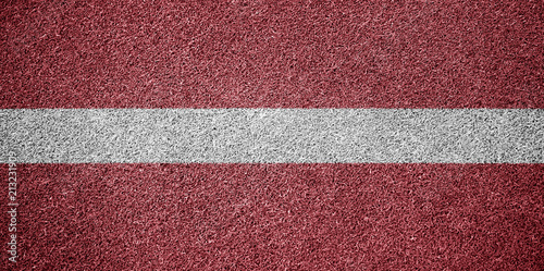 Latvia Flag Grass Sports Field Texture Background © Bernulius