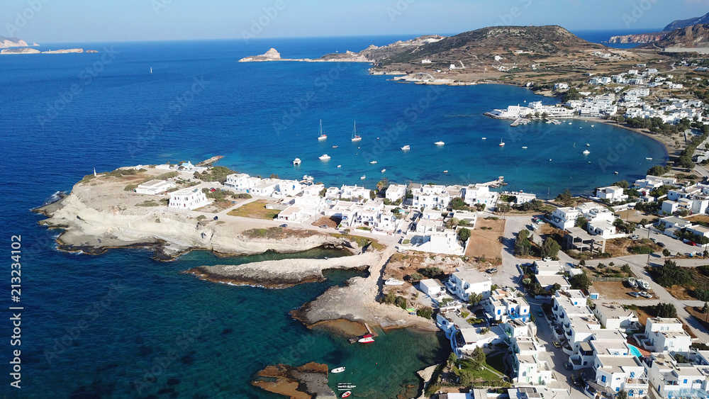 Obraz premium Aerial drone bird's eye view photo of picturesque fishing village of Polonia with traditional fishing boars docked next to island of Kimolos, Milos island, Cyclades, Greece
