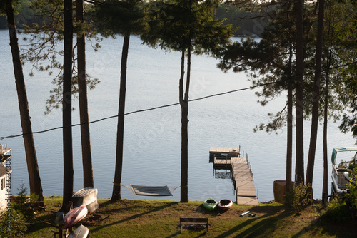 Wooden dock and a bench on a quiet lake photo