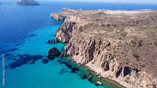 Aerial drone bird's eye view of volcanic and exotic rocky beach with turquoise and sapphire clear waters of Plathiena in island of Milos, Cyclades, Greece