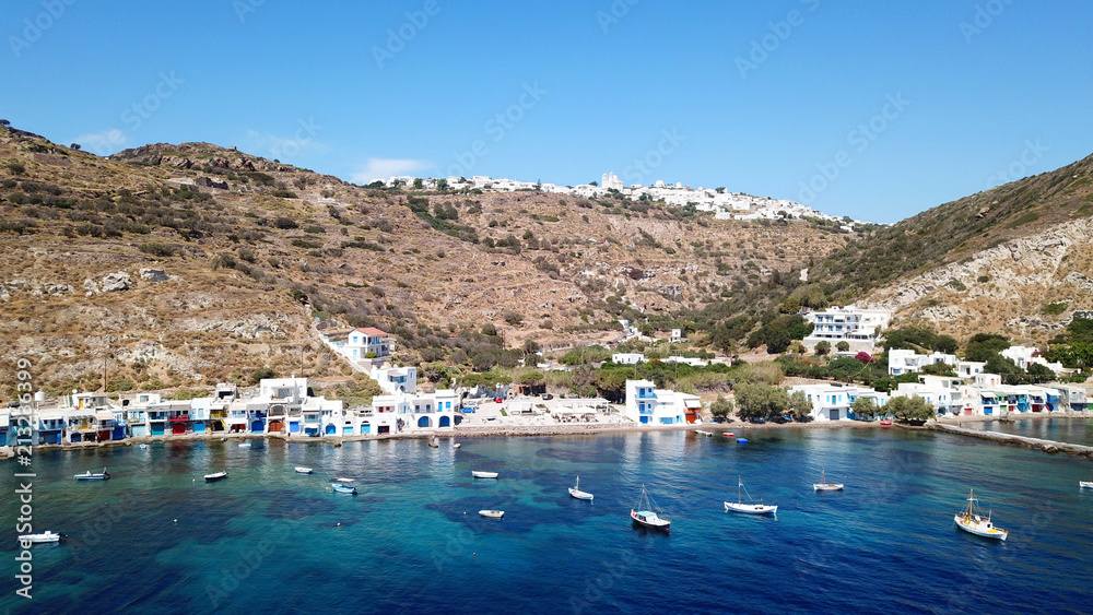 Aerial drone bird's eye view photo of picturesque and colourful fishing village of Klima with traditional character and uphill village of Plaka at the background, Milos island, Cyclades, Greece