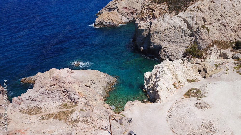 Aerial drone bird's eye view photo of picturesque fishing village of Firopotamos with traditional boat docks called syrmata, small chapel and turquoise water beach, Milos island, Cyclades, Greece