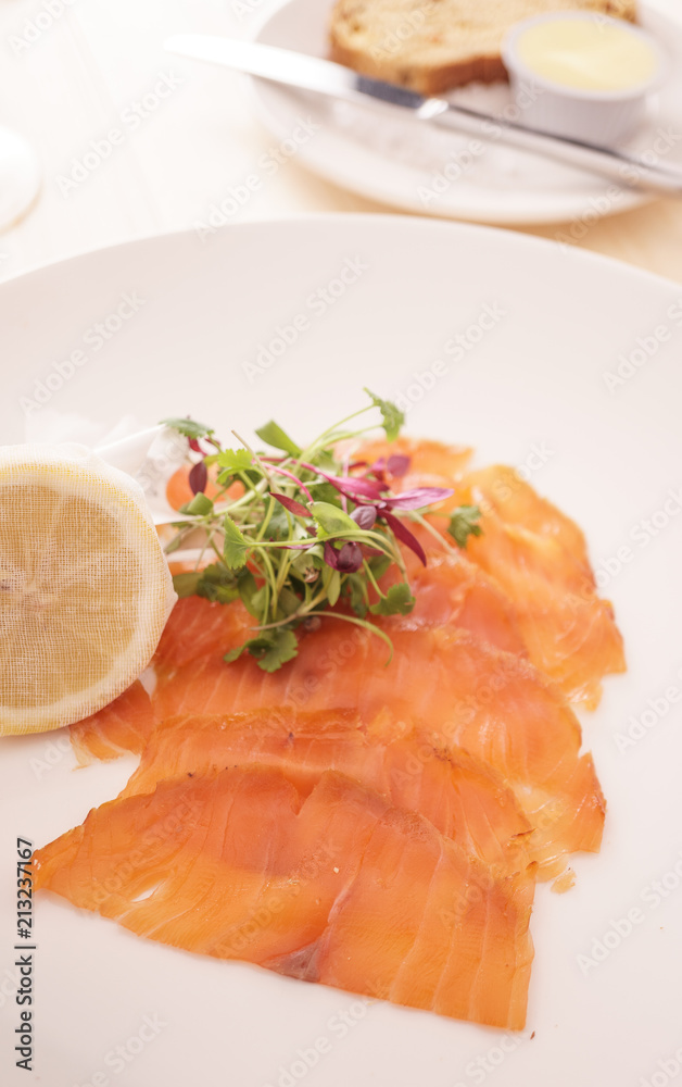 Slices of Wild Smoked Scottish Salmon with a Muslin Wrapped Half Lemon Slices of Wild Smoked Scottish Salmon with a Muslin Wrapped Half Lemon