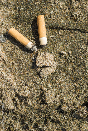 Cigarette buds left on a beach.