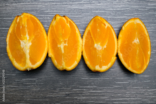 Orange fruit. Orange slice isolate on black wood. photo