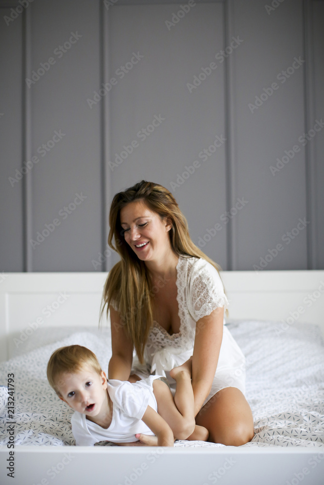 Young mother with son in the bed Young mother with son in the bed
