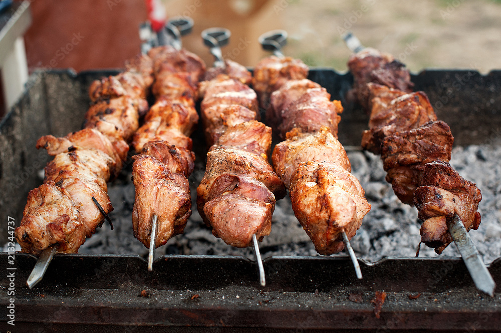Preparation of shish kebab on barbeque. Roasting on charcoal in the open air