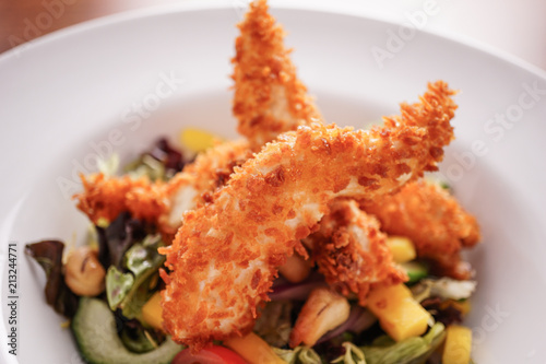Deep Fried Chicken Goujons Served with a Medley Of Mediterranean Vegetables. 
