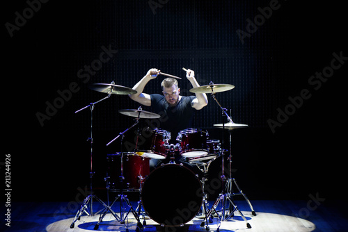 Slika na platnu Silhouette drummer on stage. Dark background, smoke spotlights