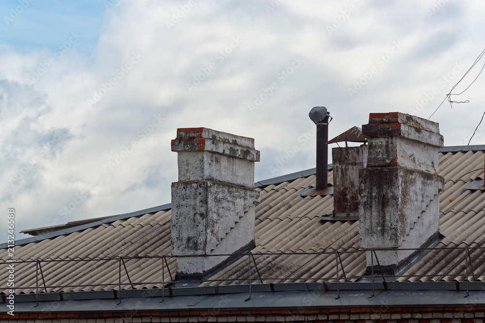 Two old chimneys on a roof of an apartment house, Komsomolsk-on-Amure, Russia Two old chimneys on a roof of an apartment house, Komsomolsk-on-Amure, Russia