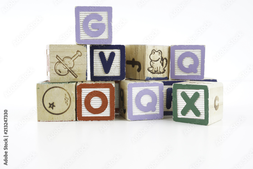 Colored wooden letter blocks on a white background with copy space Colored wooden letter blocks on a white background with copy space